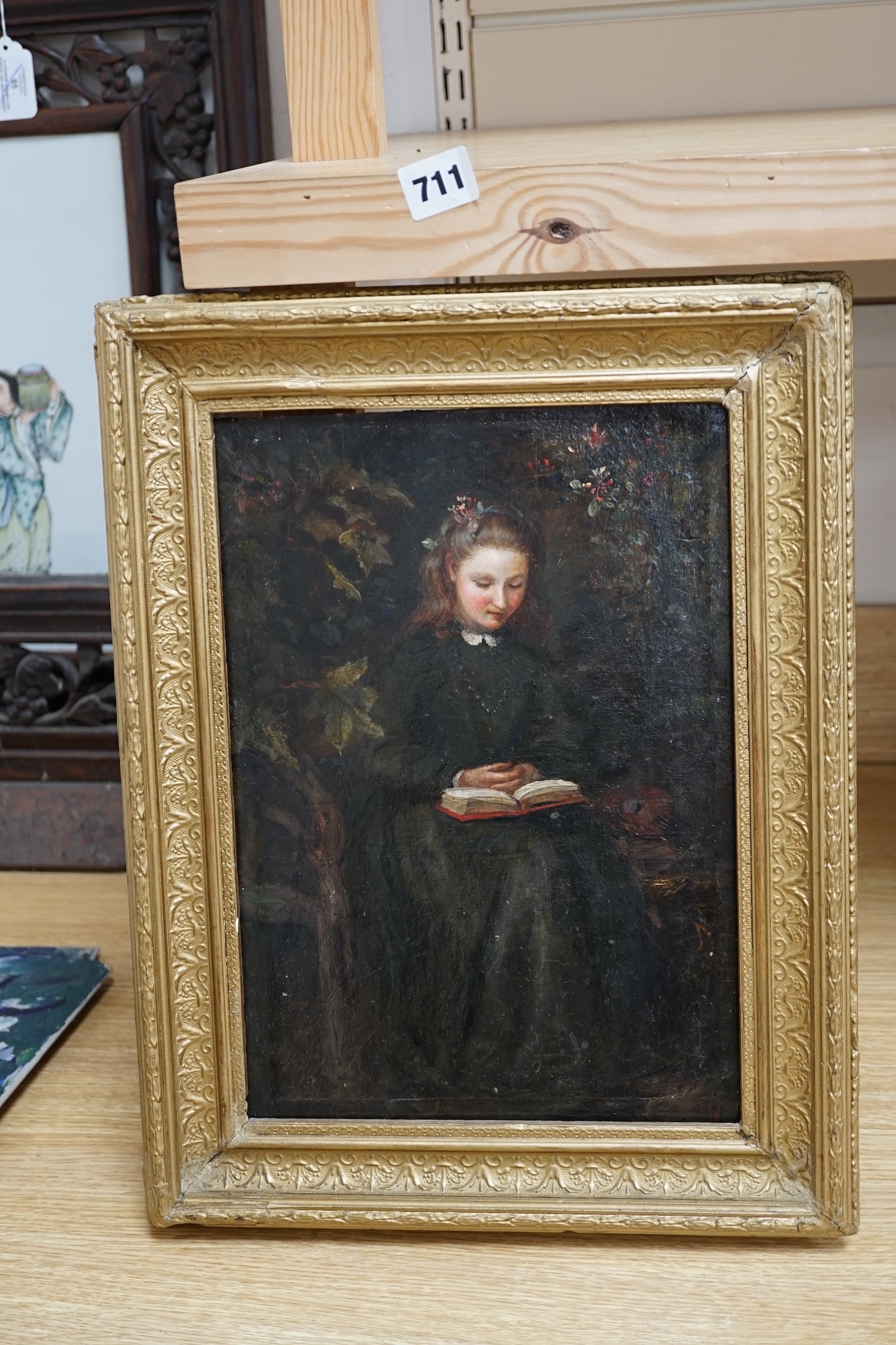 Pre-Raphaelite, oil on board, Study of a girl reading beside a peacock feather, indistinctly inscribed in ink verso, 32 x 42cm, gilt frame. Condition - fair, evidence of retouching